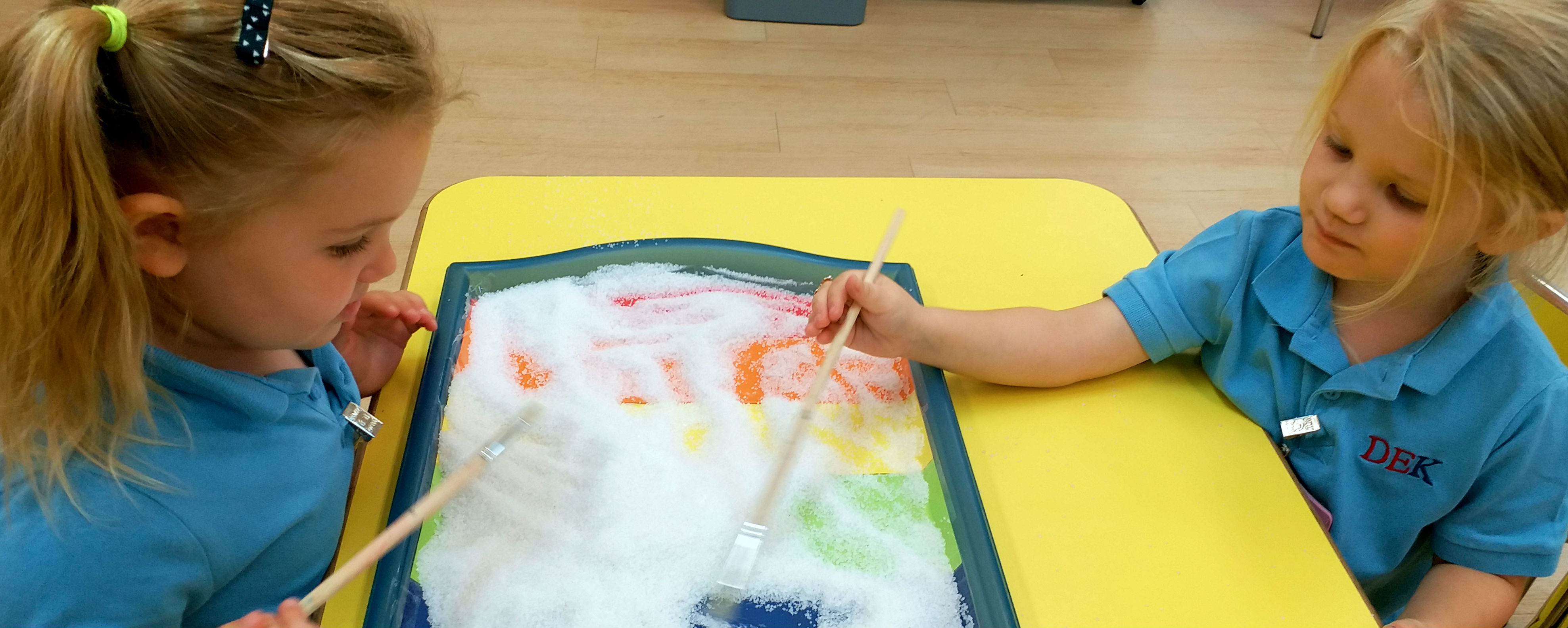 Kindergarten girls playing with sand